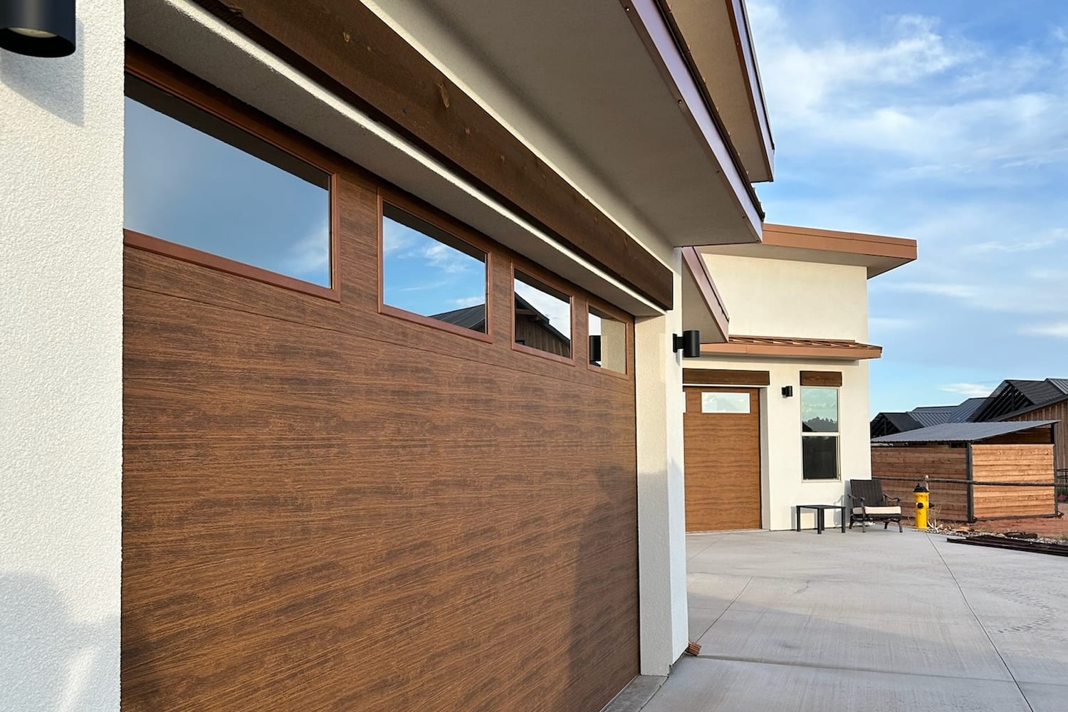 Newly completed St. George home exterior with garage doors and fresh concrete