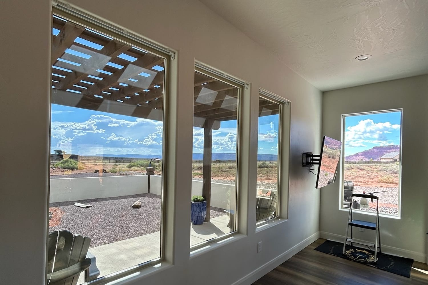 Hallway windows kept clear on a regular cleaning rhythm, looking out to the desert