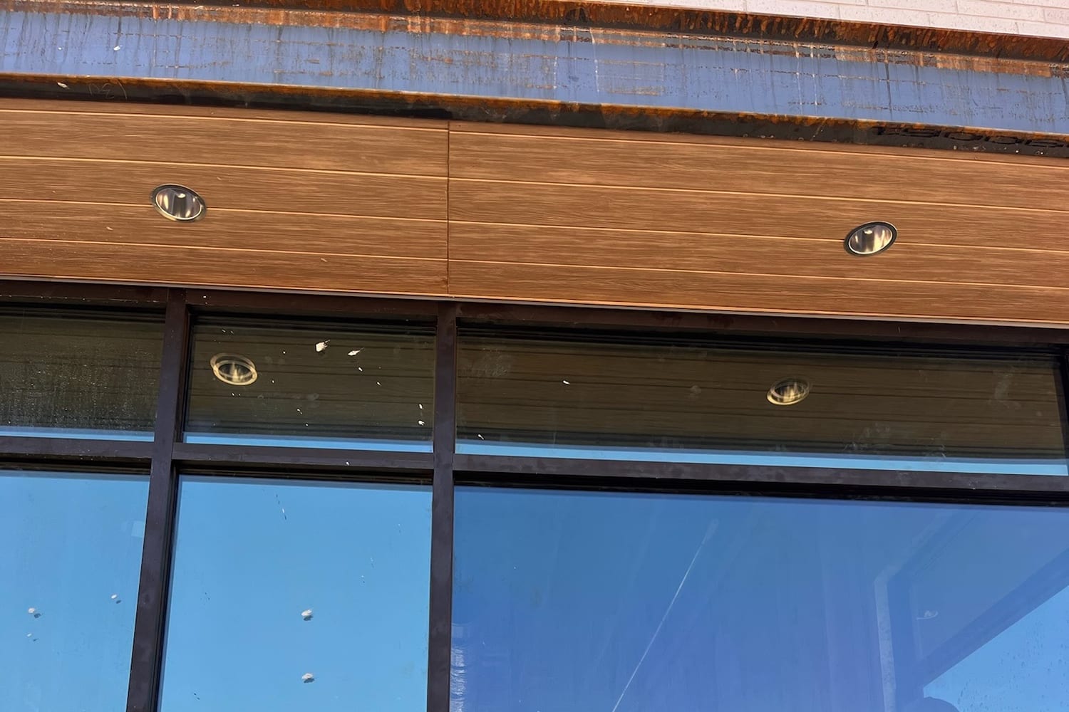 Tinted residential glass under a wood soffit reflecting the Southern Utah sky