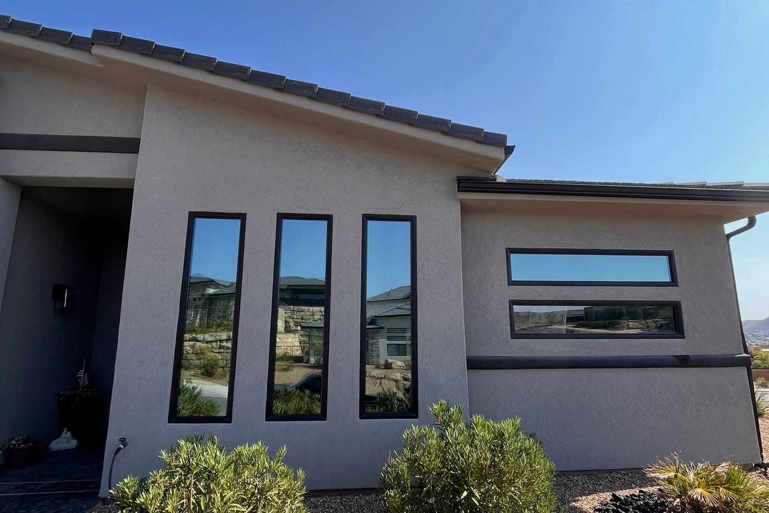 Modern St. George home with tinted vertical windows reflecting the desert