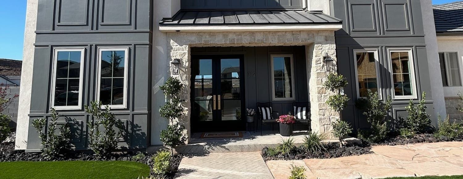 Front of a two-story St. George home with tall windows on both sides of the entry