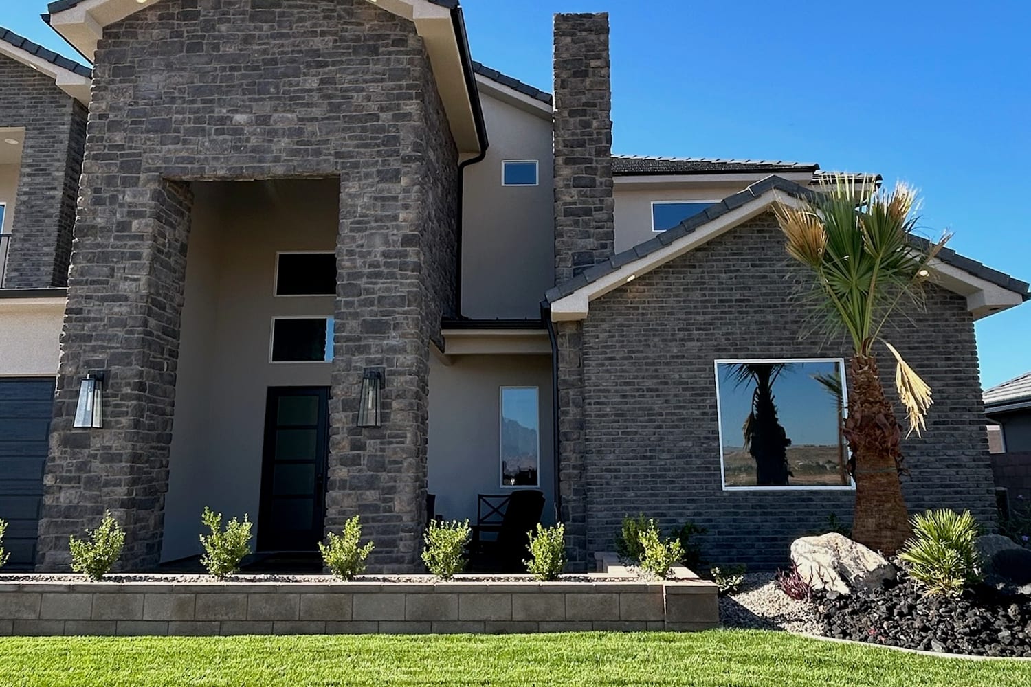 Two-story St. George home with stone and stucco elevation and tinted upper-floor windows