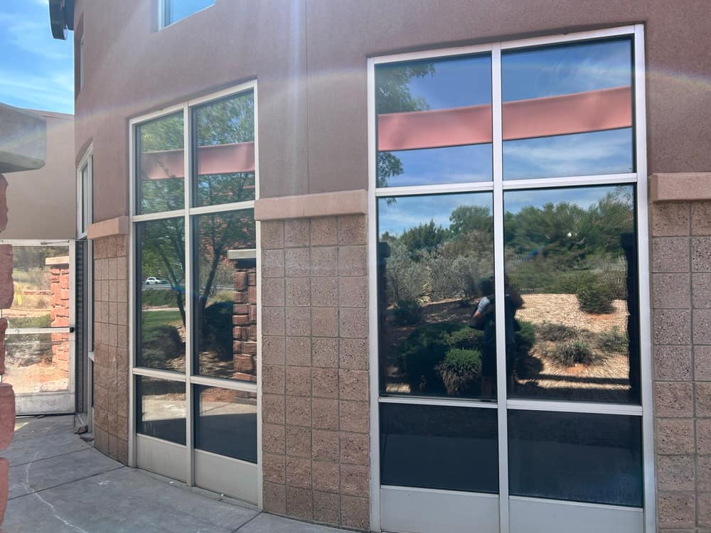 Mirror-finish tinted commercial windows reflecting the Southern Utah landscape