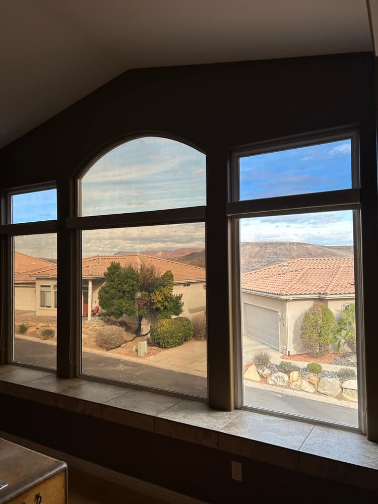 Arched picture windows framing a red-rock desert view